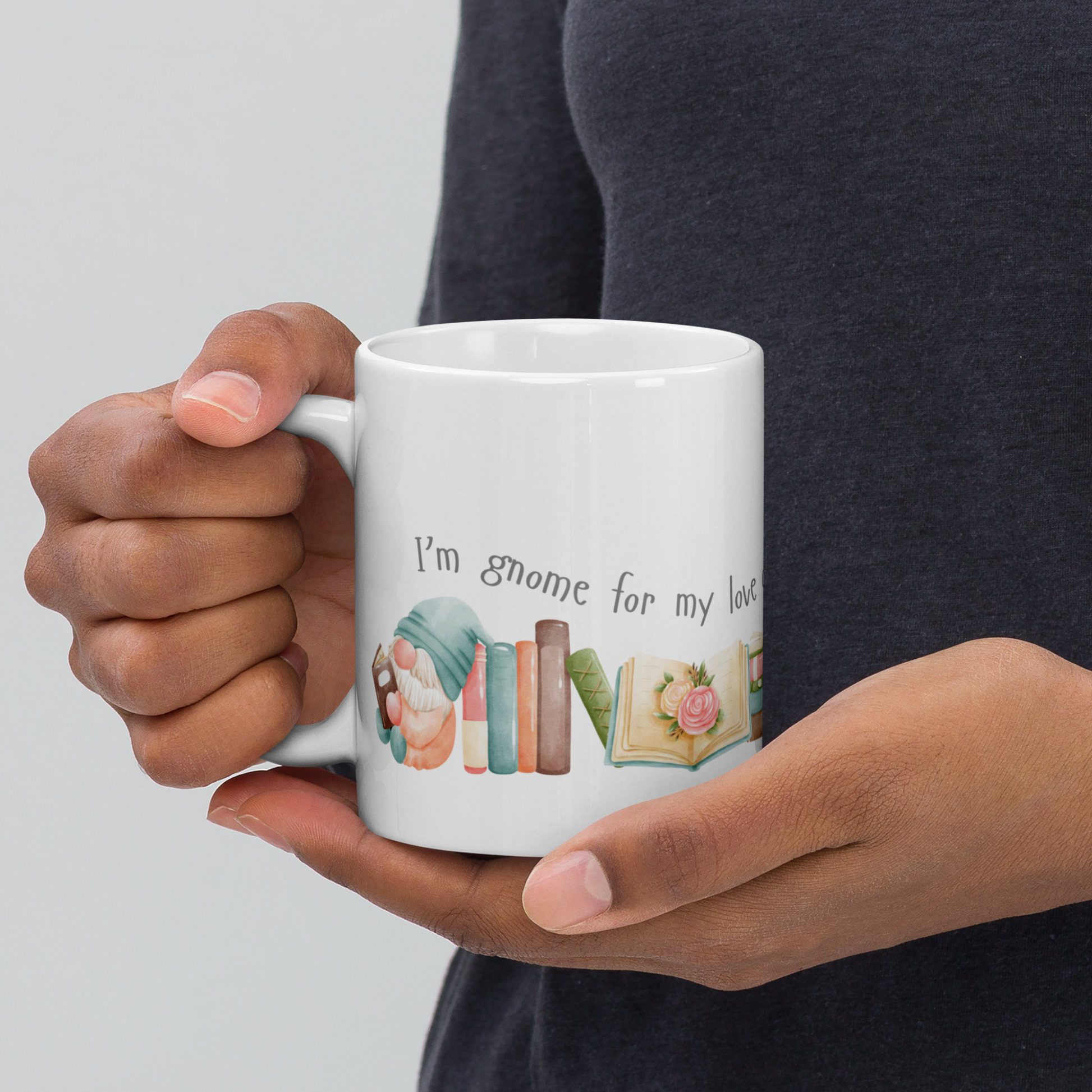 A ceramic mug in 11 and 15 oz sizes with cute little gnomes reading books and a caption that reads I'm gnome for my love of books. A great gift mug for those who love reading and gnomes. 